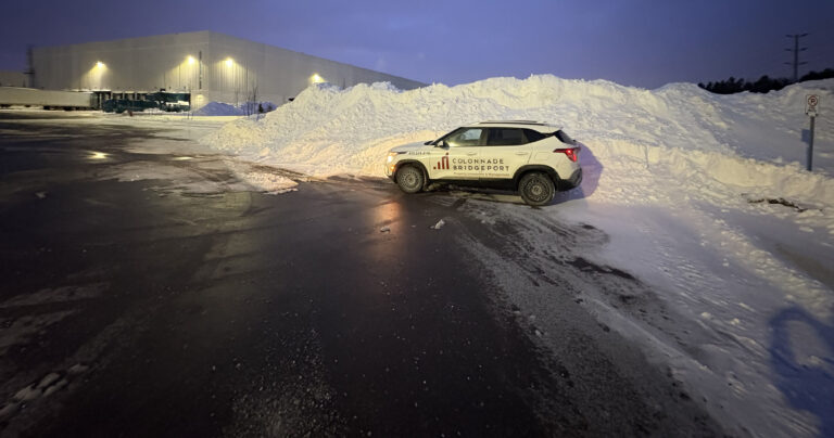 CBP Vehicle beside large snowbank